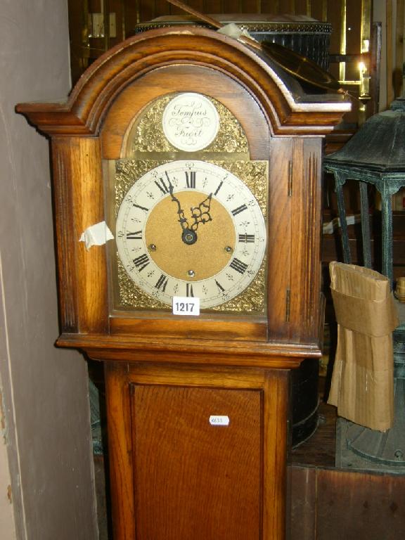 Appraisal: An Edwardian oak framed grandmother clock with arched hood enclosing