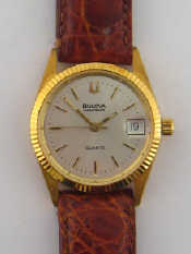 Appraisal: Bulova a mid-size carat yellow gold quartz calendar wristwatch the