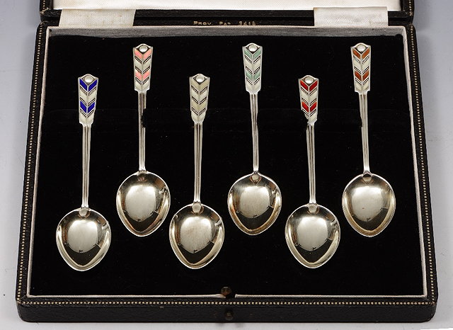 Appraisal: A CASED SET OF SIX SILVER TEASPOONS with enamelled handles