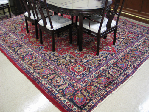 Appraisal: PERSIAN MASHAD CARPET hand knotted in a floral and floral