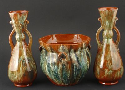 Appraisal: A Watcombe Torquay terracotta garniture possibly designed by Dr Christopher