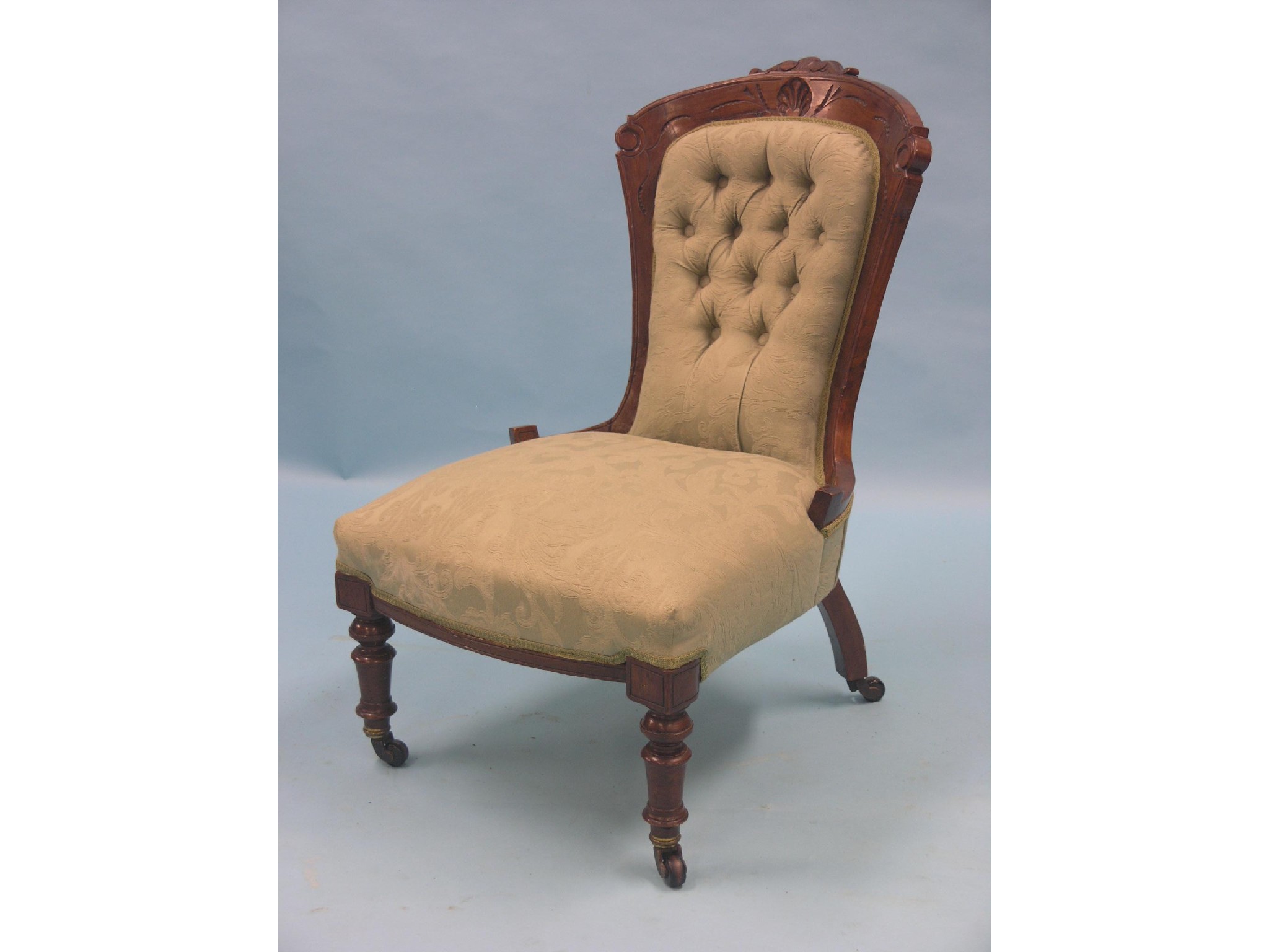 Appraisal: A Victorian walnut nursing chair frame lightly carved with foliage