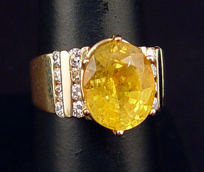 Appraisal: YELLOW SAPPHIRE AND DIAMOND RING K yellow gold ring featuring