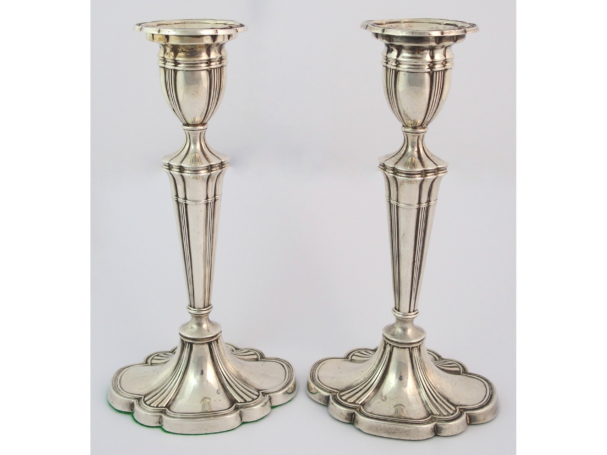 Appraisal: A pair of silver candlesticksby Dingley Brothers Birmingham the tapering