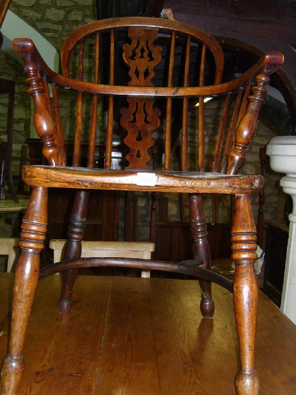 Appraisal: A Georgian comb back elbow chair principally in ash yew