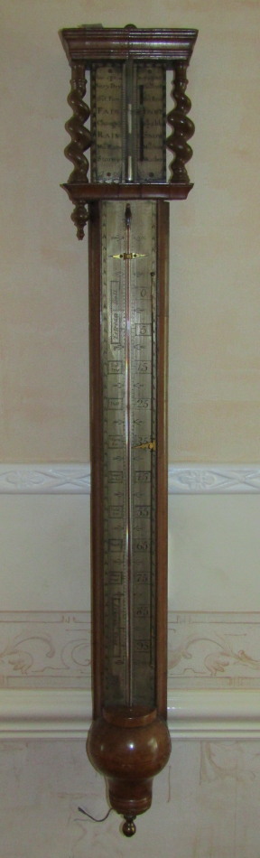 Appraisal: A thC walnut stick barometer thermometer with barleytwist columns enclosing