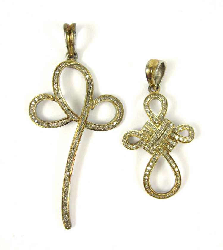 Appraisal: TWO DIAMOND AND GOLD TONE SILVER PENDANTS including a silver