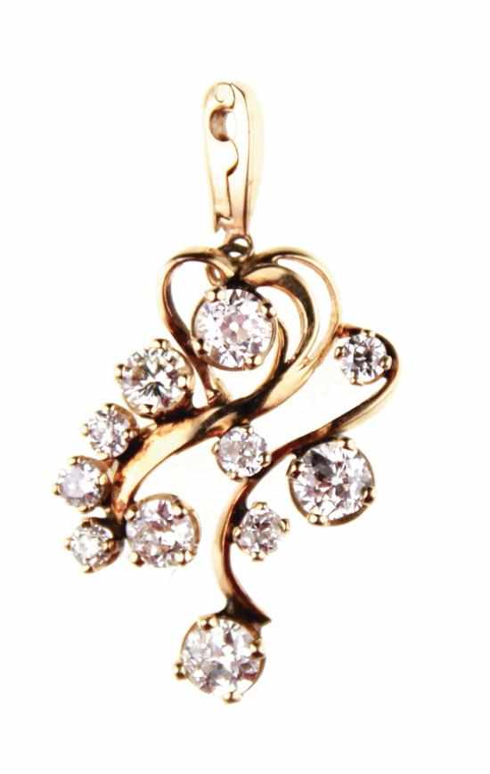 Appraisal: Diamond and gold free-form pendant prong-set with eleven round European-cut