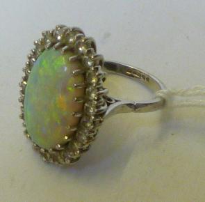 Appraisal: AN OPAL AND DIAMOND CLUSTER RING the oval cabochon polished