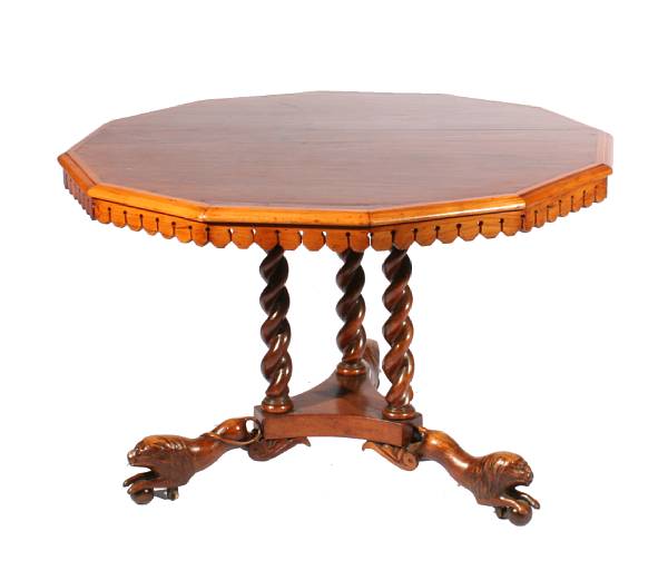 Appraisal: An English mixed wood center table with carved lion detail