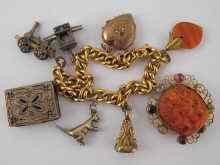 Appraisal: A carat gold charm bracelet including a carved coral charm