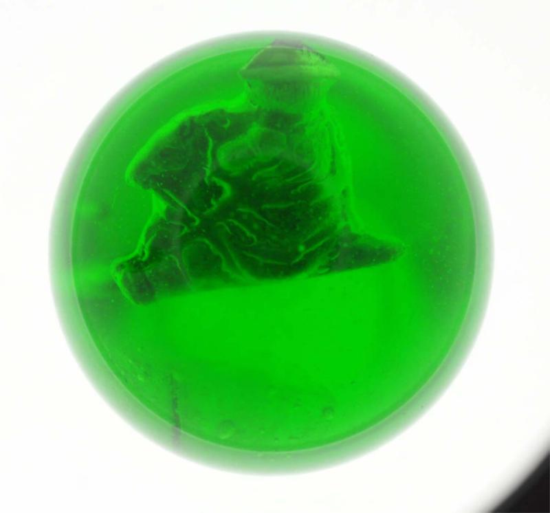 Appraisal: Apple green base glass Figure is a boy with hat