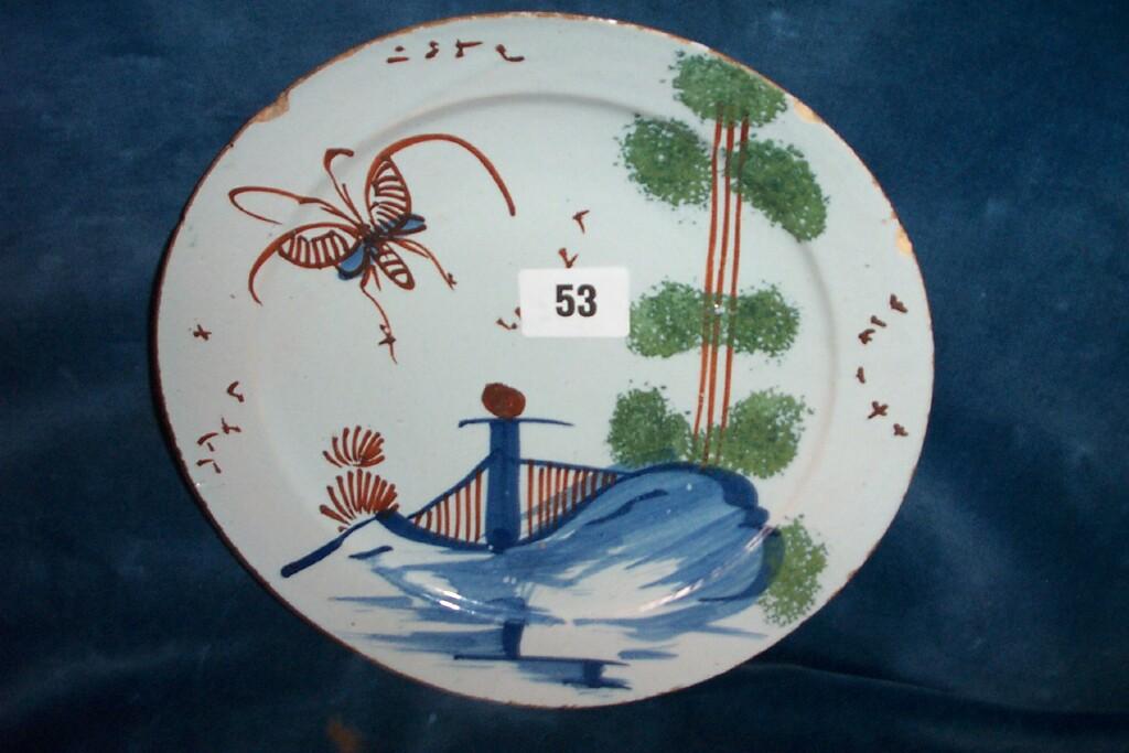 Appraisal: An th century tin glazed earthenware plate with polychrome painted