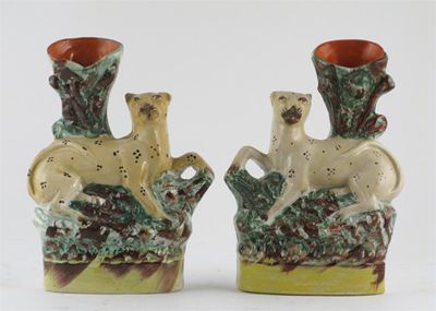 Appraisal: A rare pair of Staffordshire spill vases modelled as leopards