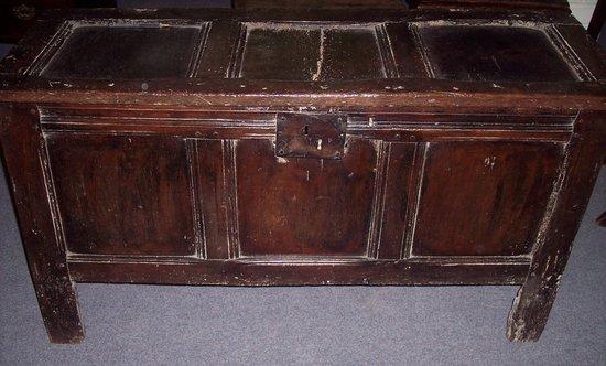 Appraisal: A plain oak chest with triple panel hinged cover and