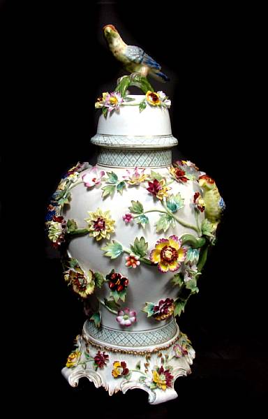 Appraisal: A pair of German style porcelain urns with flowers birds