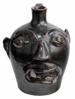 Appraisal: Browns Pottery Face Jug dark black glaze applied facial features