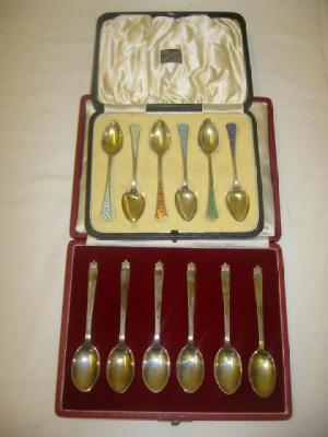 Appraisal: A SET OF SIX GILDED TEASPOONS each with individually enamelled