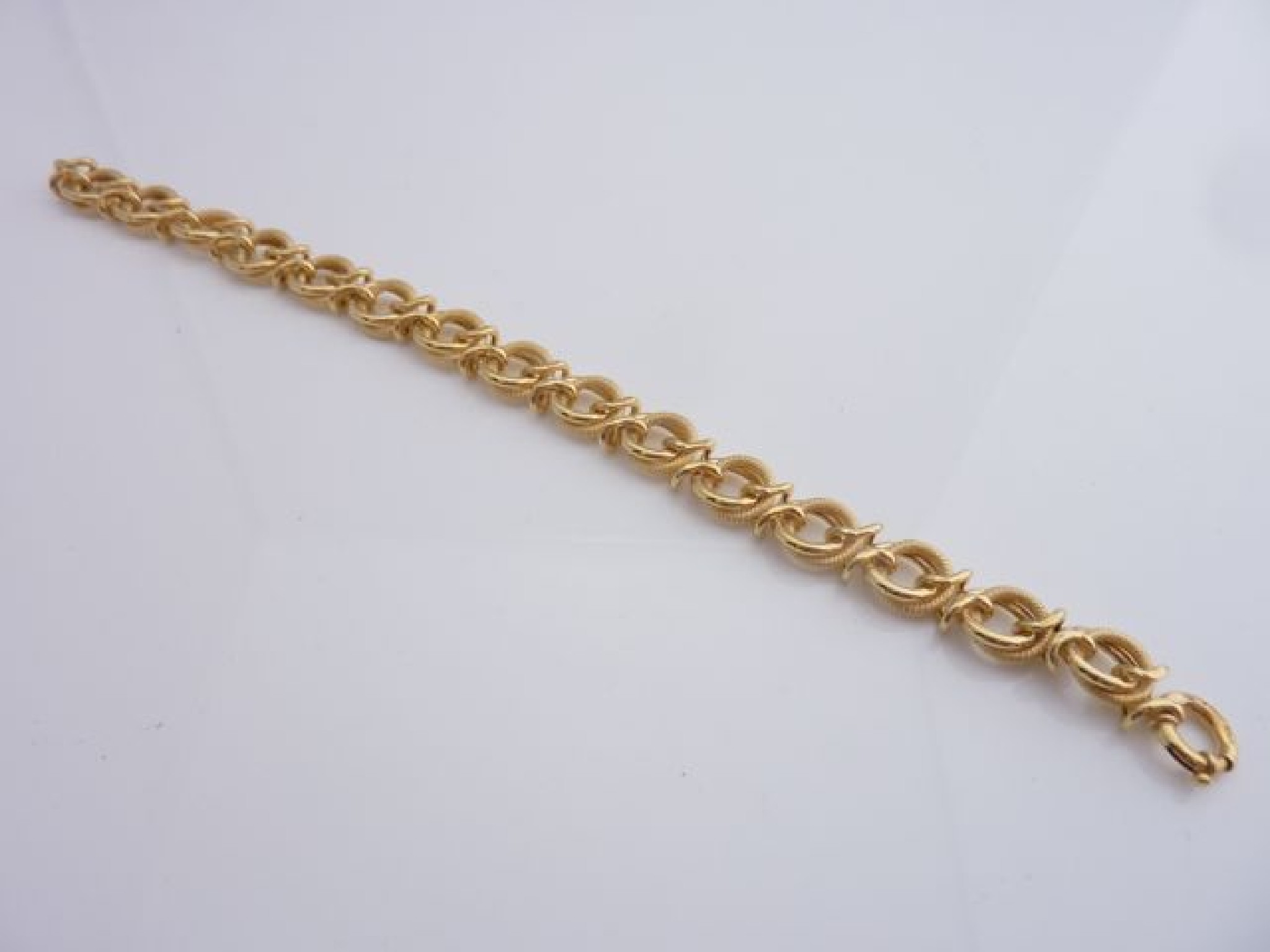 Appraisal: A ct gold hollow-link bracelet composed of polished and textured