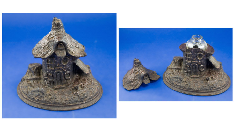 Appraisal: Tree House Inkwell Cast Iron House with Thatch Lid containing