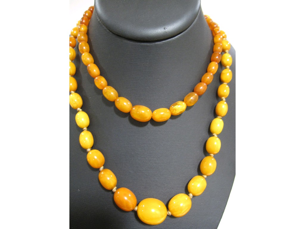 Appraisal: Two strings of yellow amber beads in in approx