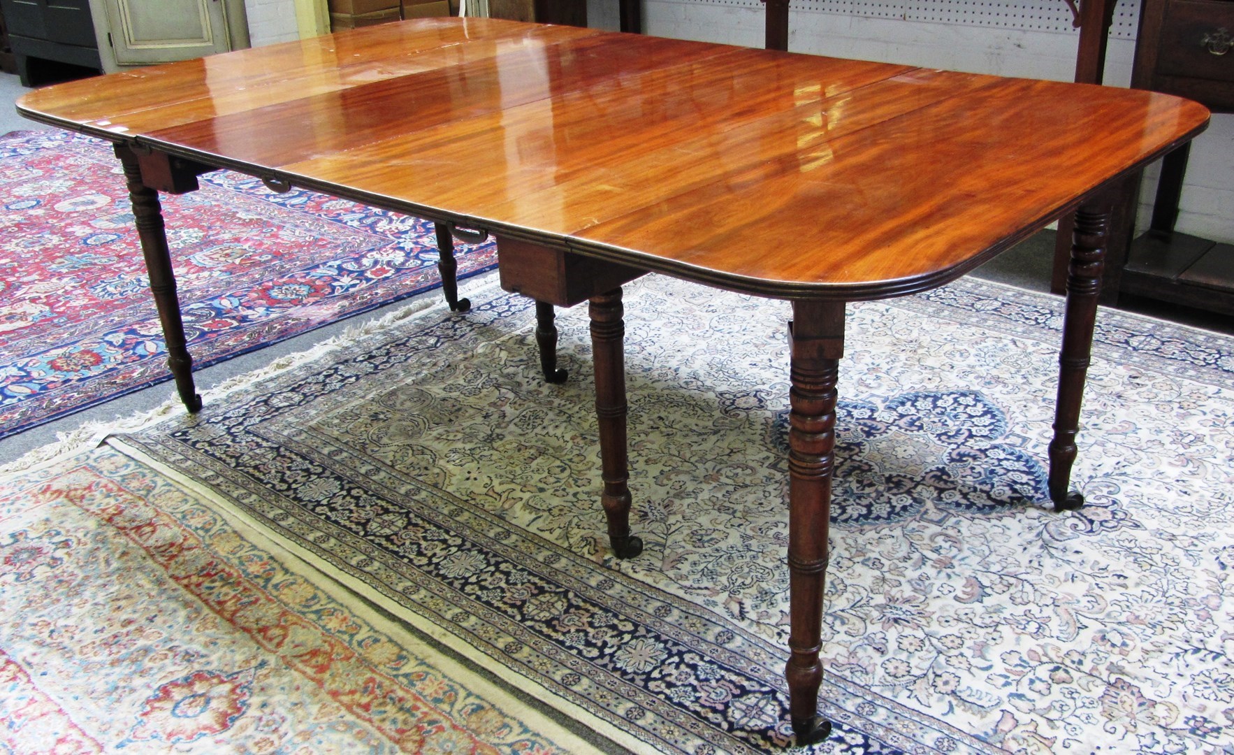 Appraisal: A Regency mahogany concertina action drop flap extending dining table