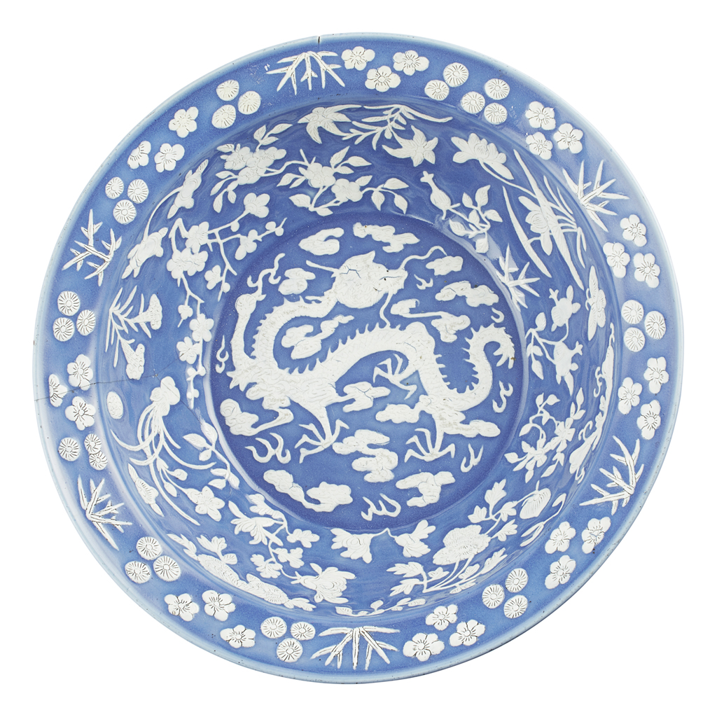 Appraisal: WHITE SLIP DECORATED BLUE GROUND 'DRAGON' BASIN heavily potted with