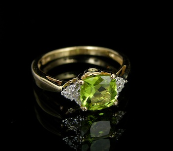 Appraisal: A Peridot and Diamond Ring k yellow gold ring features