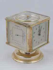 Appraisal: A combination clock barometer thermometer compass hygrometer the clock rotating