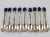 Appraisal: Nine white metal tests silver tea spoons set with blue