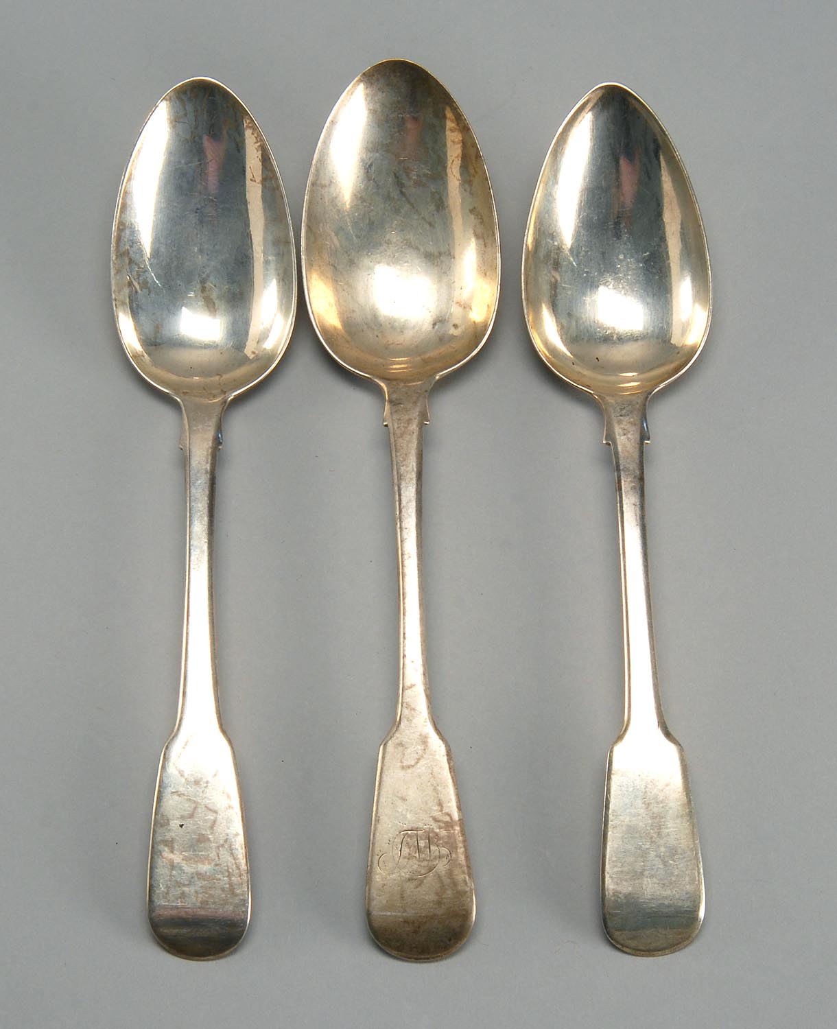 Appraisal: THREE ENGLISH SILVER TABLESPOONS th th CenturyVarious makers Approx troy