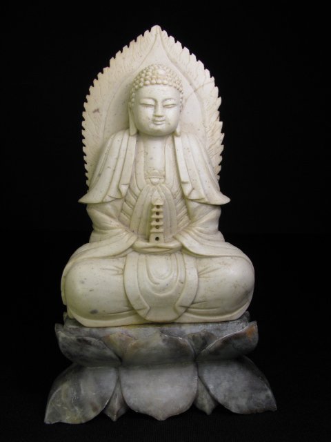 Appraisal: Twentieth century Chinese carved stone Buddha sitting on a lotus