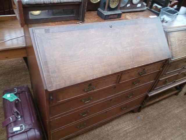 Appraisal: AN OAK BUREAU the fall front enclosing fitted interior over