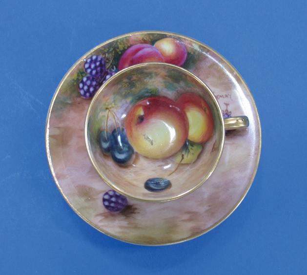 Appraisal: A ROYAL WORCESTER MINIATURE TEA CUP AND SAUCER with hand