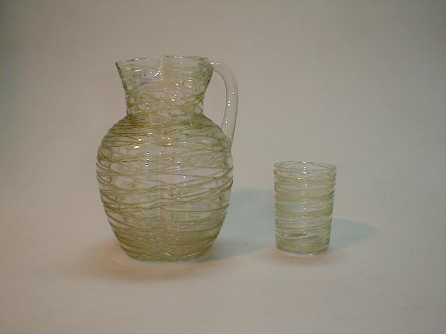 Appraisal: A clear glass jug and tumbler with applied green string