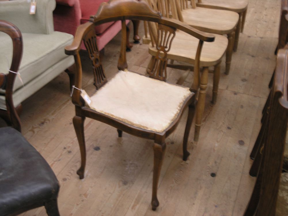 Appraisal: An Edwardian inlaid mahogany corner fitting armchair with upholstered seat