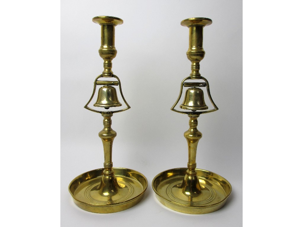 Appraisal: A pair of brass club candl