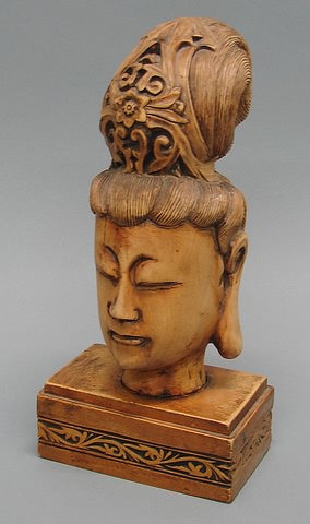 Appraisal: Elaborate hairdo oblong plinth with carved leaf-scrolled band t Condition