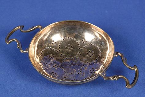 Appraisal: A GEORGE II LEMON STRAINER of conventional form with openwork