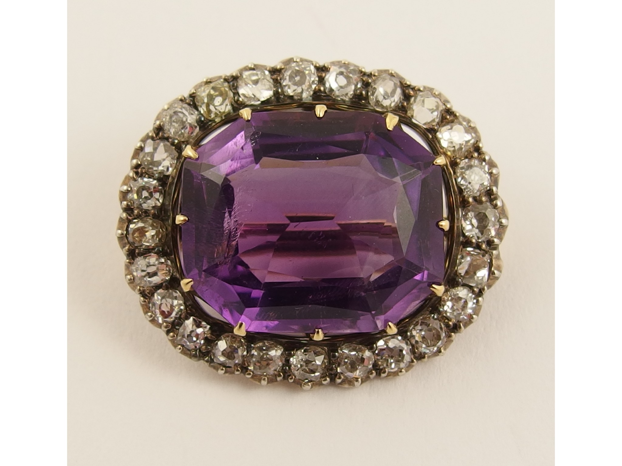 Appraisal: An amethyst and diamond broocha large mixed cut amethyst in