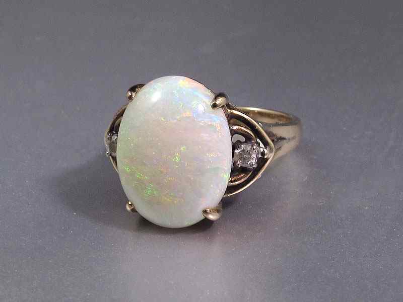 Appraisal: CT OPAL RING WITH DIAMONDS K yellow gold ring contains