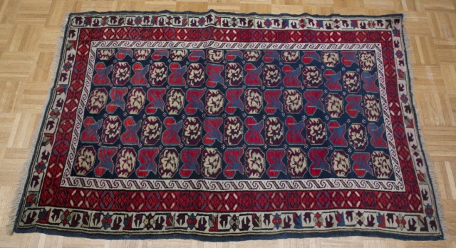 Appraisal: Persian Rug Bright red and blue geometric patterns with three