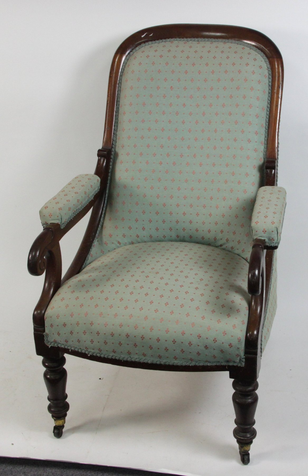 Appraisal: A Victorian walnut armchair with scroll arms and turned legs