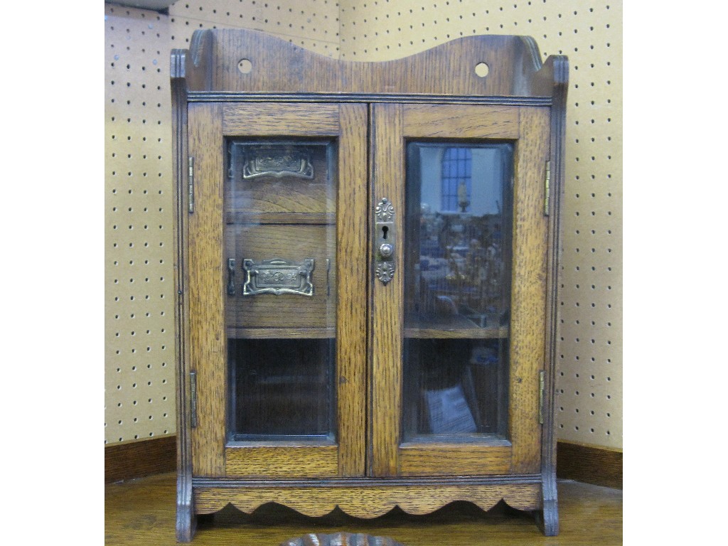 Appraisal: Oak glazed door smoker's cabinet