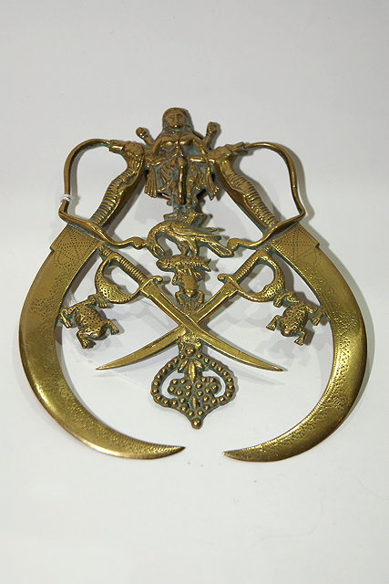 Appraisal: A BRASS PROBABLY INDIAN MILITARY SMALL HANGING MOUNT in the