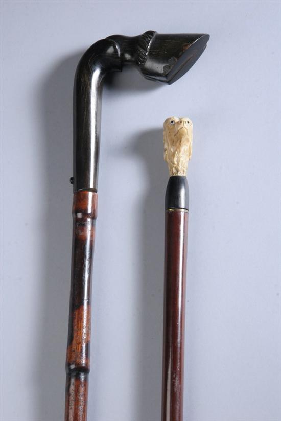 Appraisal: TWO WEAPON CANES One small carved ivory head of spaniel