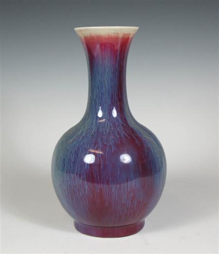 Appraisal: A Chinese flamb glazed bottle shaped vase deep red and