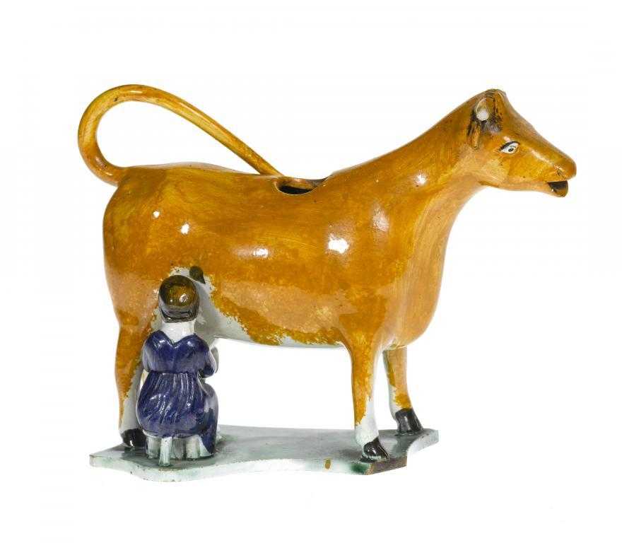 Appraisal: A PRATT WARE COW CREAMER the bellowing bright ochre cow