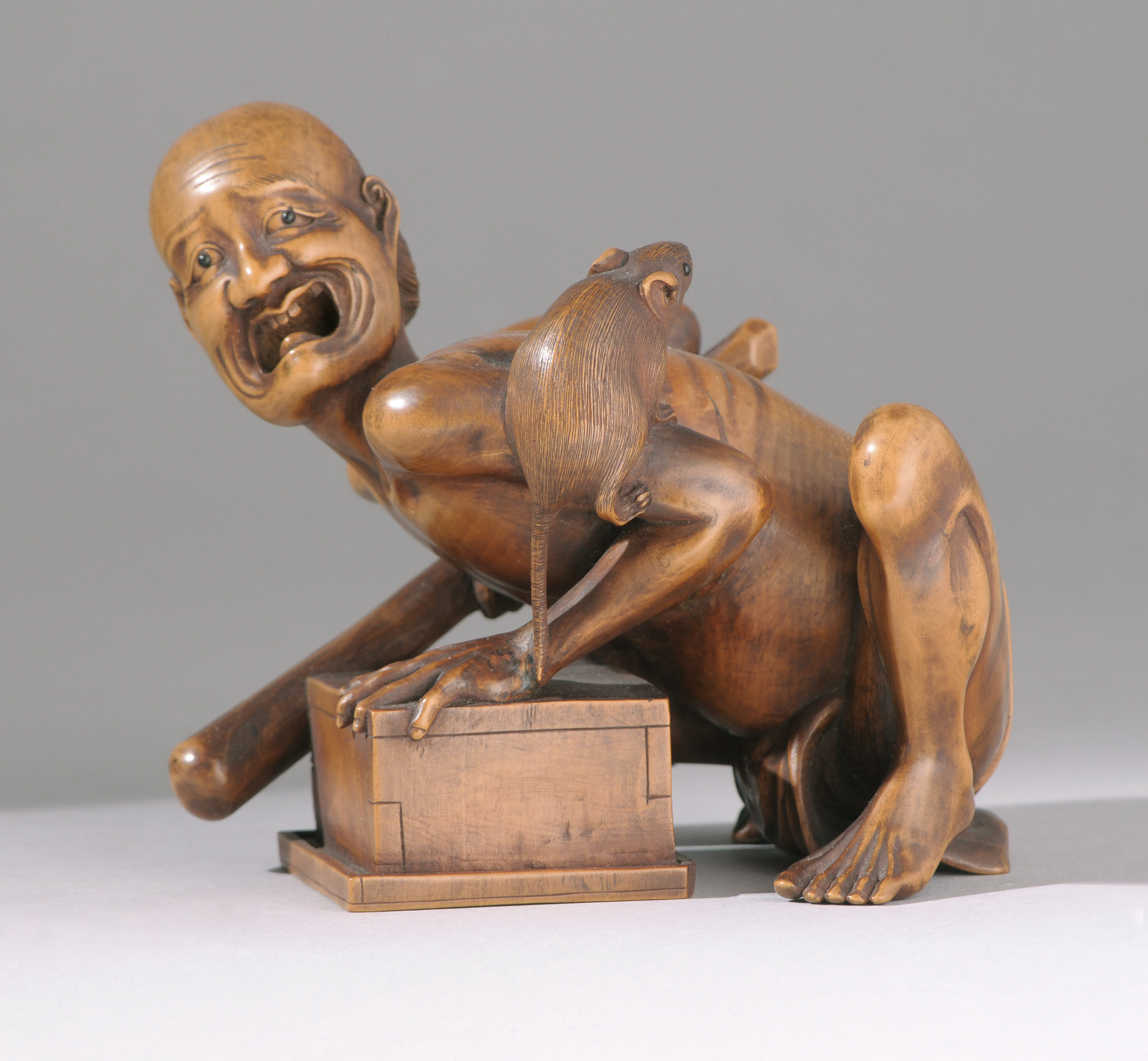 Appraisal: WOOD OKIMONO Meiji PeriodDepicting a disappointed rat catcher with a