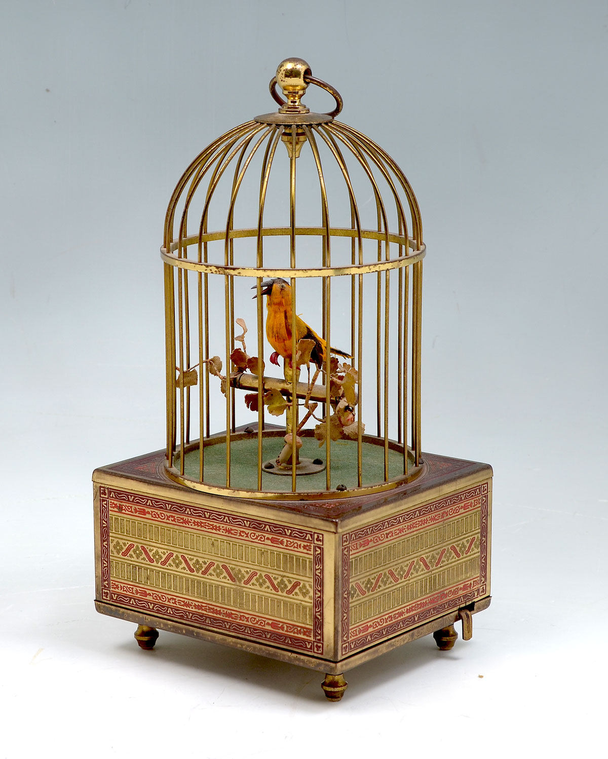 Appraisal: SINGING BIRD IN CAGE AUTOMATON Black yellow singing bird perched